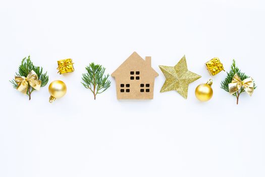 Merry Christmas and Happy Holidays, Miniature house with Christmas composition. gifts, pine branches and decorations on white background. Copy space