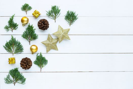 Merry Christmas and Happy Holidays, Christmas composition. golden stars, pine branches and decorations on white wooden background. Top view 