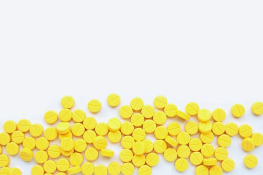 Yellow tablets of Paracetamol on white background.  Copy space