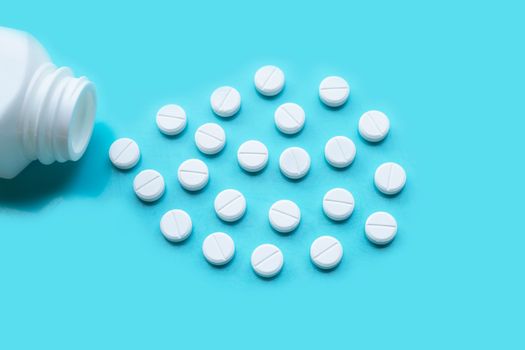 Tablets of Paracetamol on blue background.  Copy space