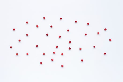 Red peppercorns  on white background.