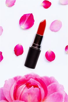 Lipstick with rose petals isolated on white background.