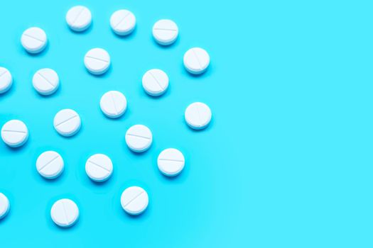 Tablets of Paracetamol on blue background. Copy space