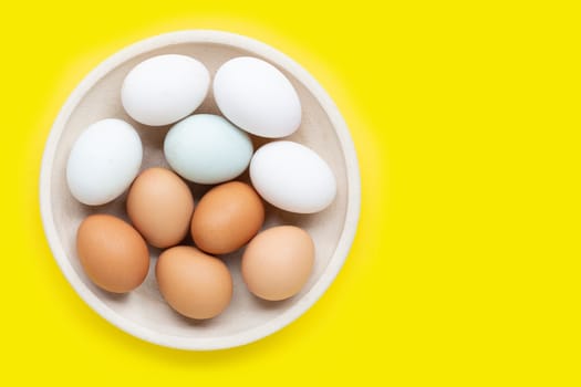 Eggs on yellow background.  Top view