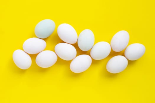 White eggs on yellow background.  Top view