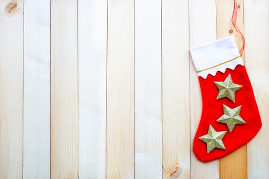 Red Christmas sock on wooden background. Top view