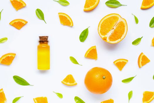 Natural citrus oil with fresh orange fruit and green leaves  on white background. High vitamin C. Top view