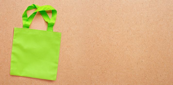 Green bag  on plywood background.  Copy space