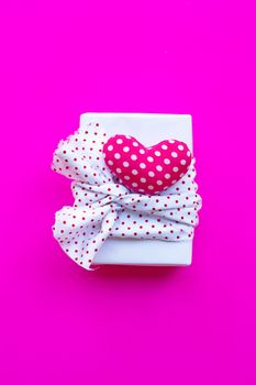 Valentine's heart with gift box  on pink background. Top view