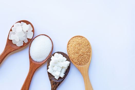 Various types of sugar on white background.