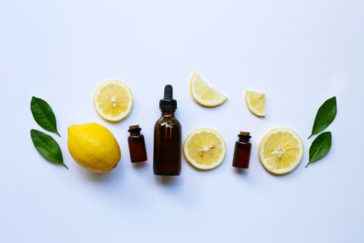 Fresh lemon with lemon essential oil on a white background.