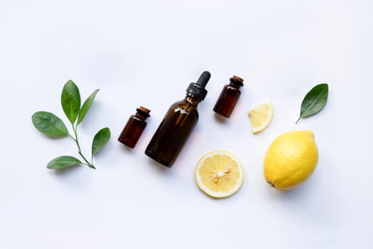 Fresh lemon with lemon essential oil on a white background.