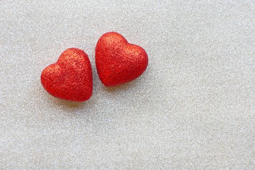 The red heart shapes on  silver glitter paper background  in love concept for valentines day. Copy space