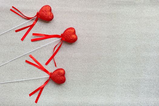 The red heart shapes on  silver glitter paper background  in love concept for valentines day. Copy space