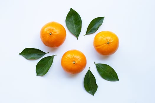 Fresh orange citrus fruit with leaves isolated on white background.  Top view