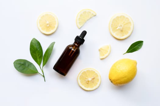 Fresh lemon with lemon essential oil on a white background.