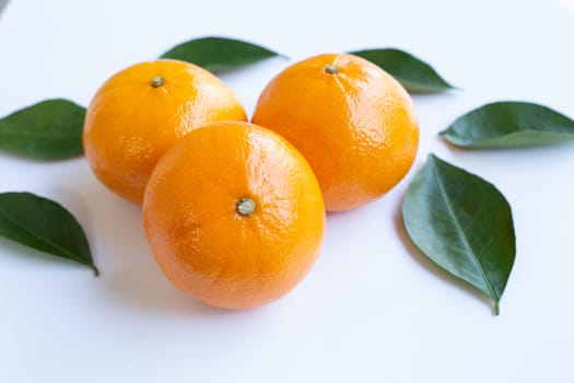 Fresh orange citrus fruit with leaves isolated on white background.  