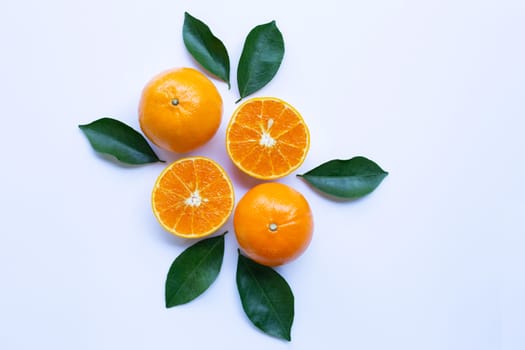 Fresh orange citrus fruit with leaves isolated on white background.  Top view