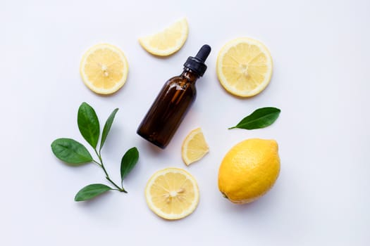 Fresh lemon with lemon essential oil on a white background.