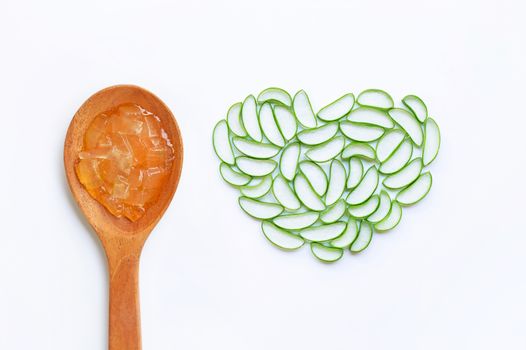 Aloe vera gel on wooden spoon with aloe vera slices on white background, heart shaped