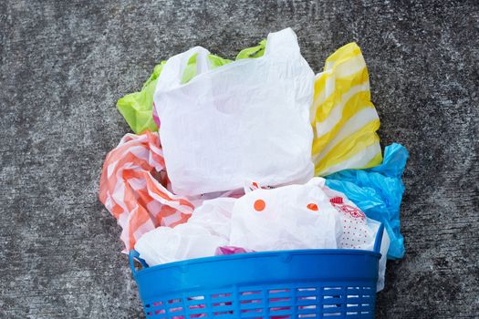 Colorful plastic bags on cement floor background