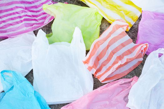 Colorful plastic waste on cement floor background.