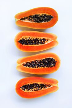 Half of ripe papaya fruit with seeds isolated on white background