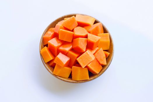 Papaya in wooden bowl on white background