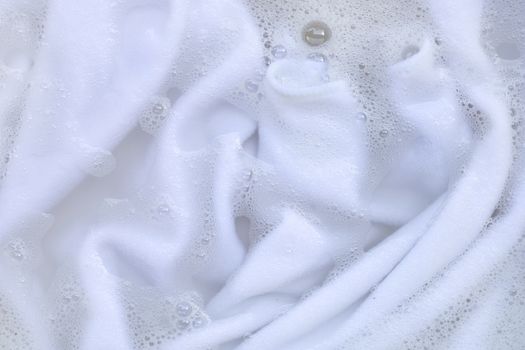 Washing clothes, white clothes soaked.