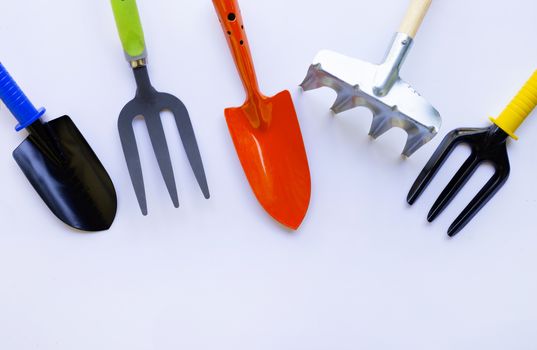 Garden shovel and fork with rake solated on white background.
