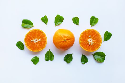 Fresh oranges with half of Bergamot kaffir lime leaves, heart shape on white background
