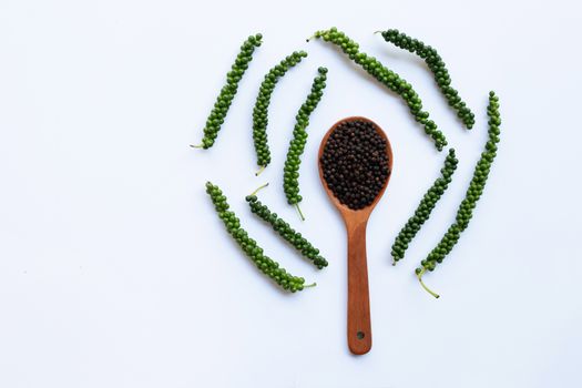 Fresh green peper with Black Pepper on white background.