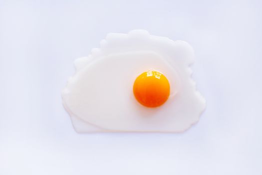Raw egg yolk on white background