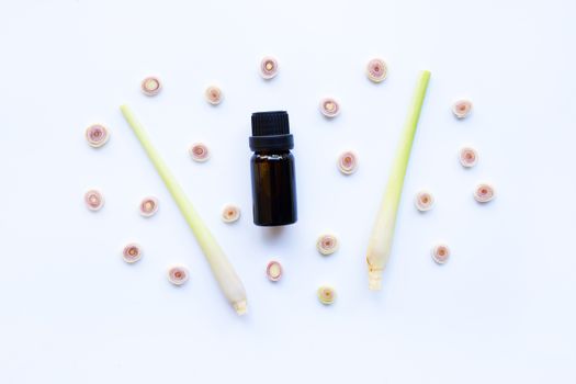 Lemon grass essential oil with sliced fresh Lemon grass on white