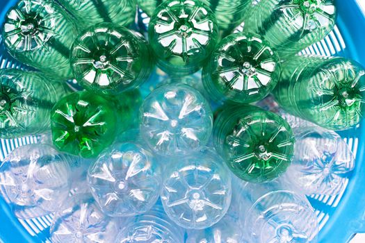 Plastic bottles in blue waste basket.