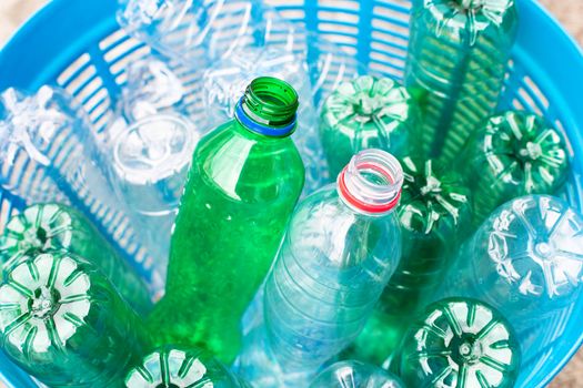 Plastic bottles in blue waste basket.
