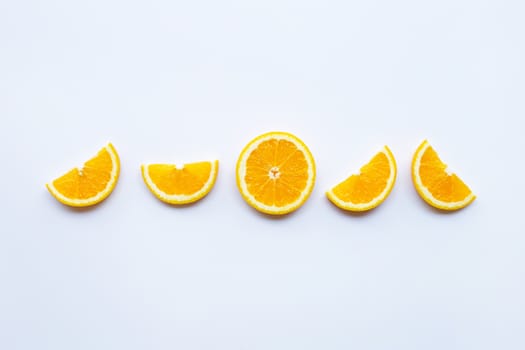 Fresh orange citrus fruit slices on white background.