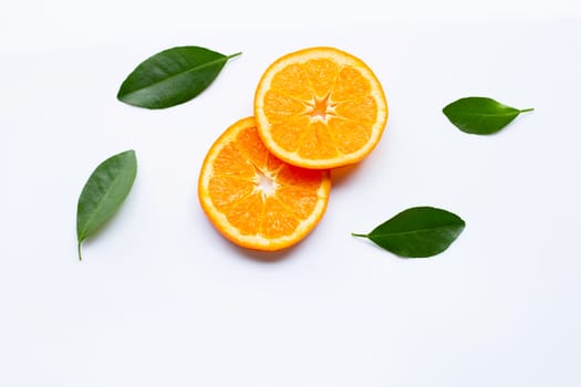 Fresh orange citrus fruit slices with leaves on white background.  Top view