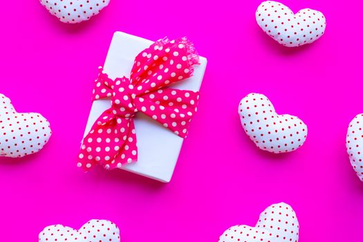 Gift box with Valentine's hearts on pink background. Top view 