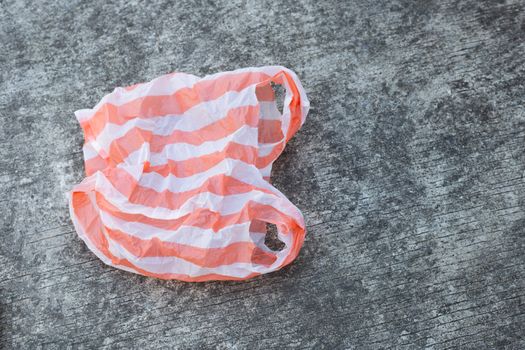 Plastic bag on cement floor background.