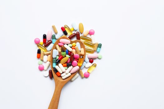 Colorful tablets with capsules and pills on white background.