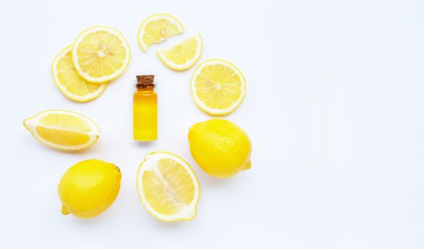 Essential oil with lemon on white background.