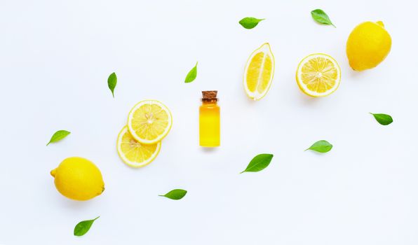 Essential oil with lemon on white background.