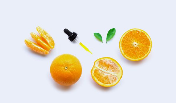Orange essential oil with dropper on white background.