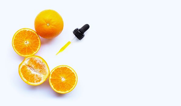 Essential oil with oranges on white background. Copy space