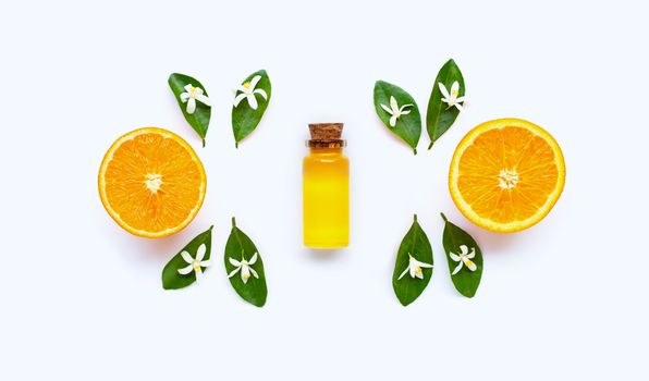 Essential oil with oranges on white background.
