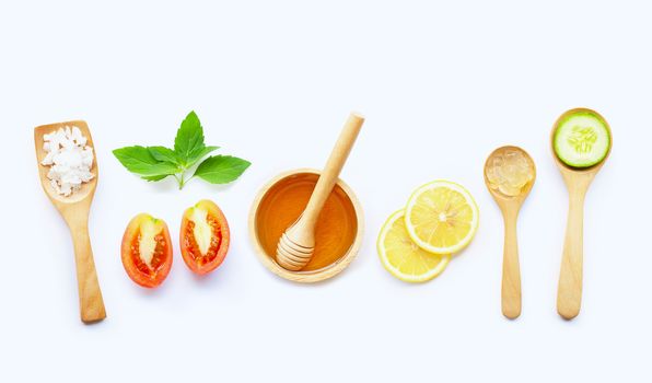 Natural ingredients for homemade skin care on white background.