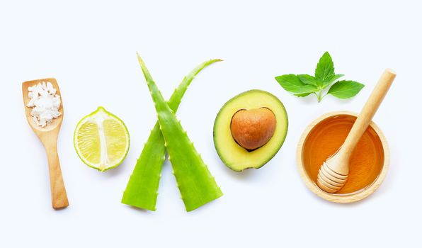 Natural ingredients for homemade skin care on white background.