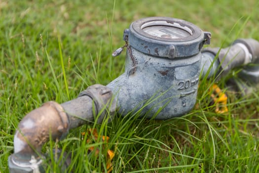 Old and rusty water meter in yard