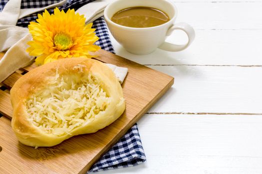 Coconut bun with cup of coffee for breakfast background.